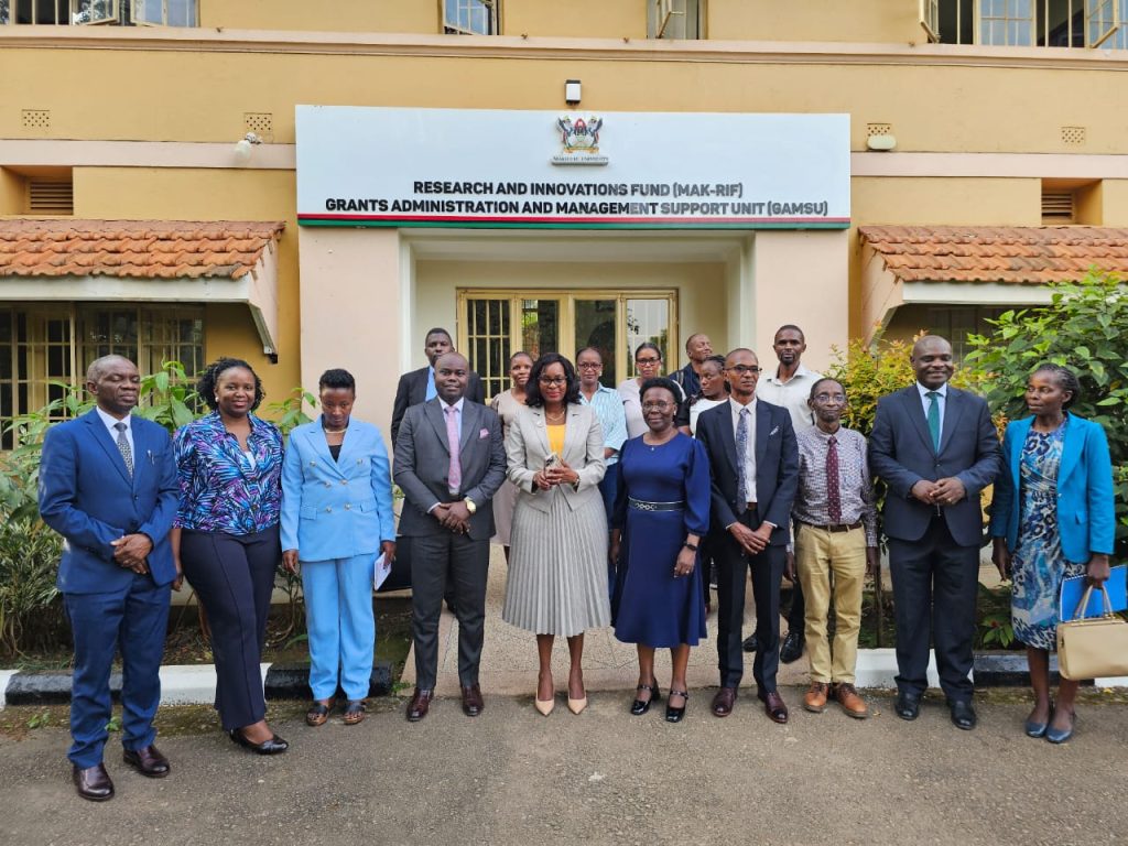 A group of officials outside the Makerere University Research and Innovations Fund (Mak-RIF) and GAMSU offices during the MUST benchmarking visit.